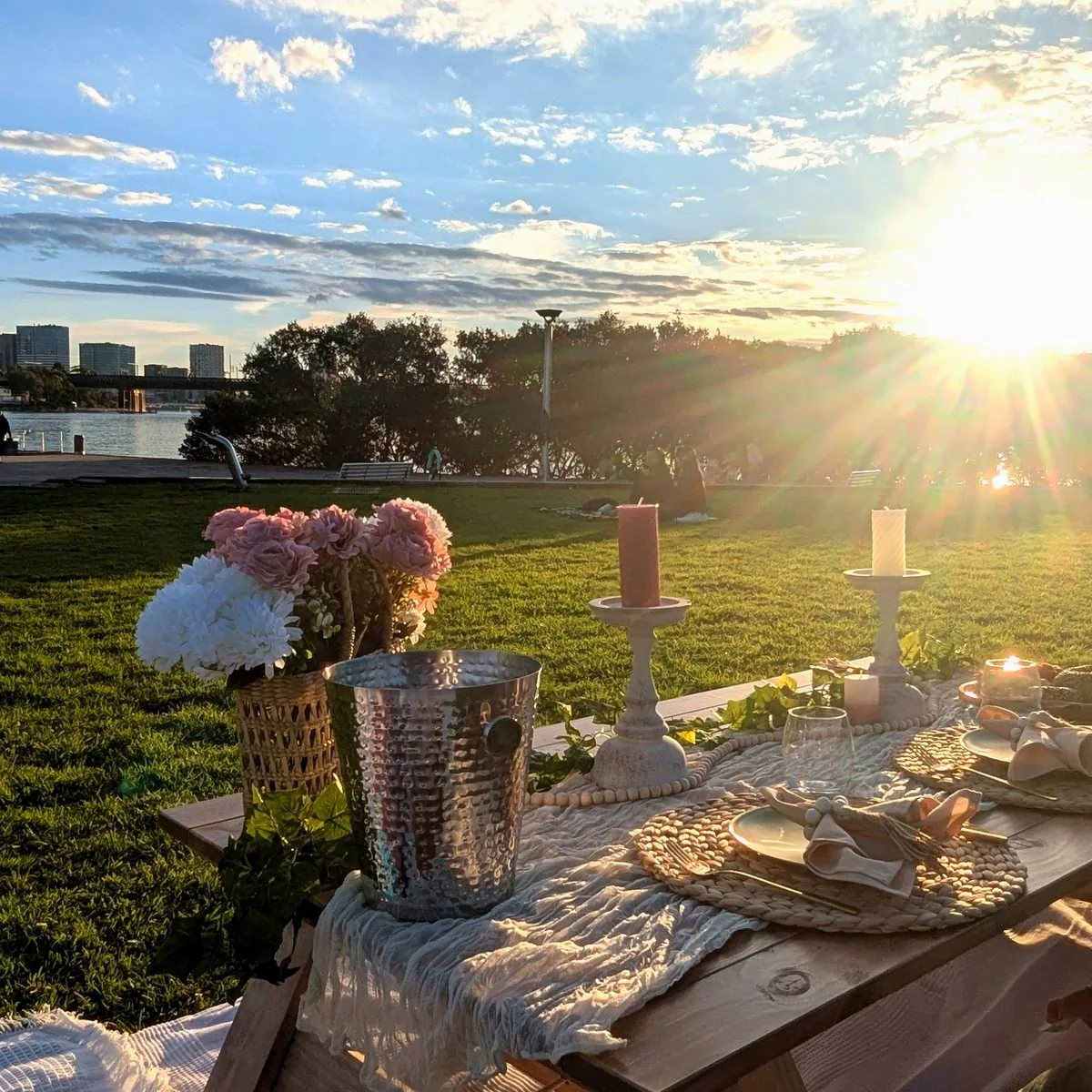 Harmony Moments picnic table styled with florals and candles at golden hour