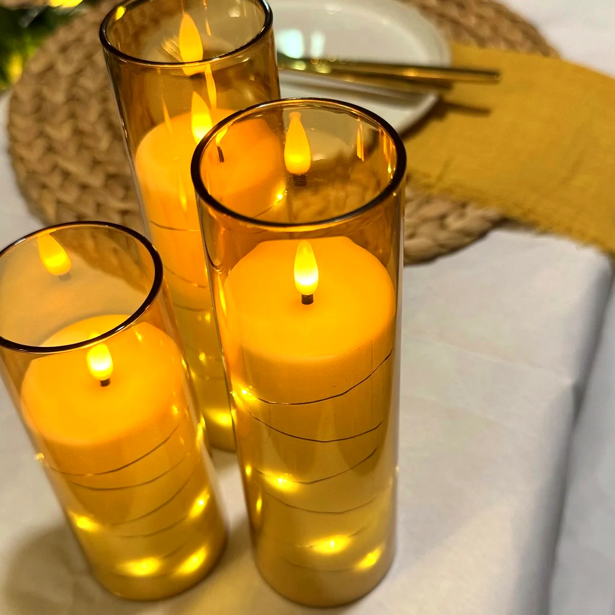 Close-up of candles and gold place settings from a real Harmony Moments setup
