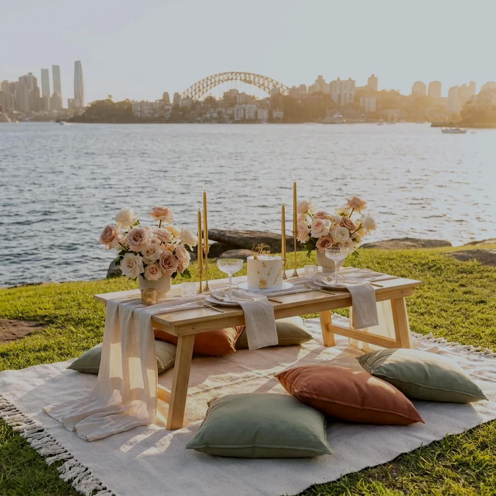 Anniversary picnic for two styled on a Sydney harbourside headland at golden hour