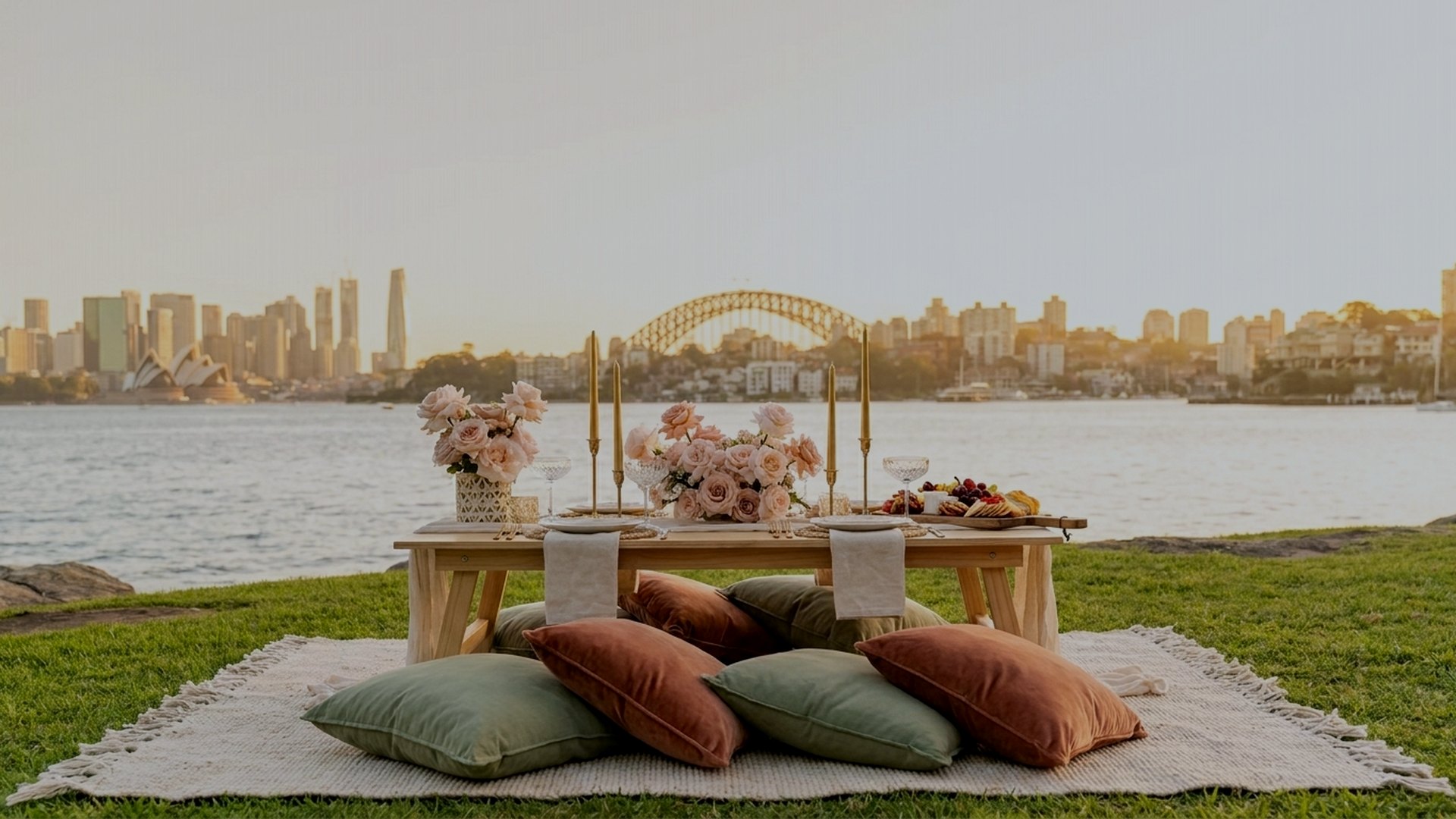 Romantic date night picnic for two styled by Harmony Moments on a Sydney harbourside lawn at golden hour