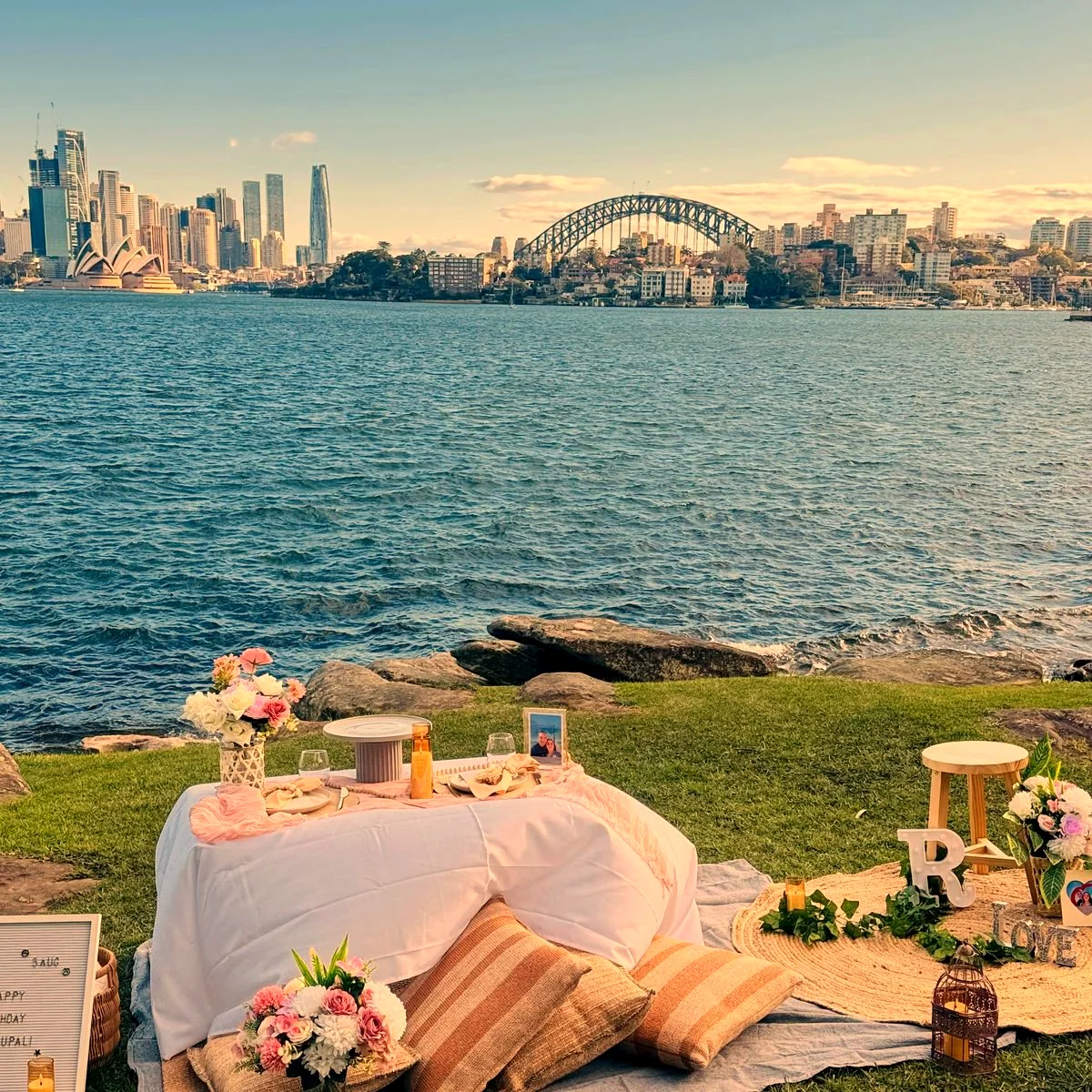 Friends celebrating a birthday at a styled picnic in a Sydney park